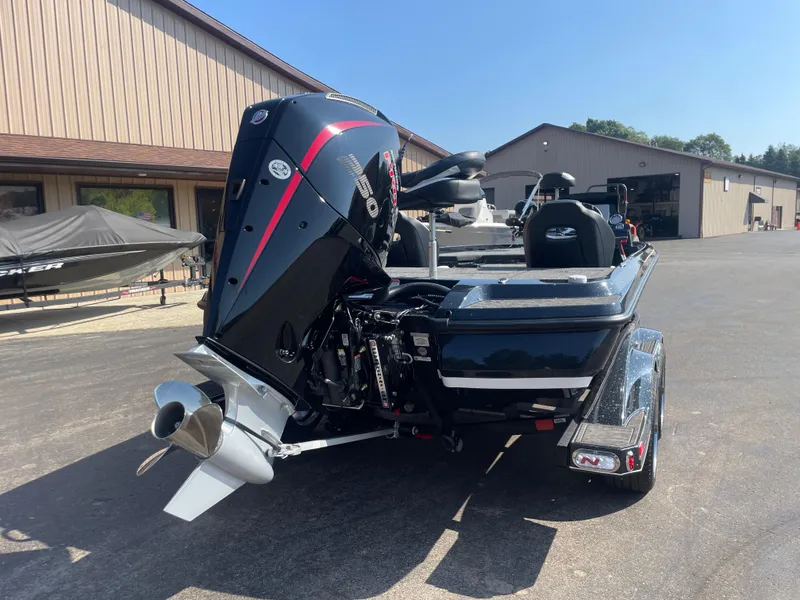 Slide: The Image of 2025 Nitro Z21 XL Pro boat with powerful outboard motor, parked outdoors. - 12