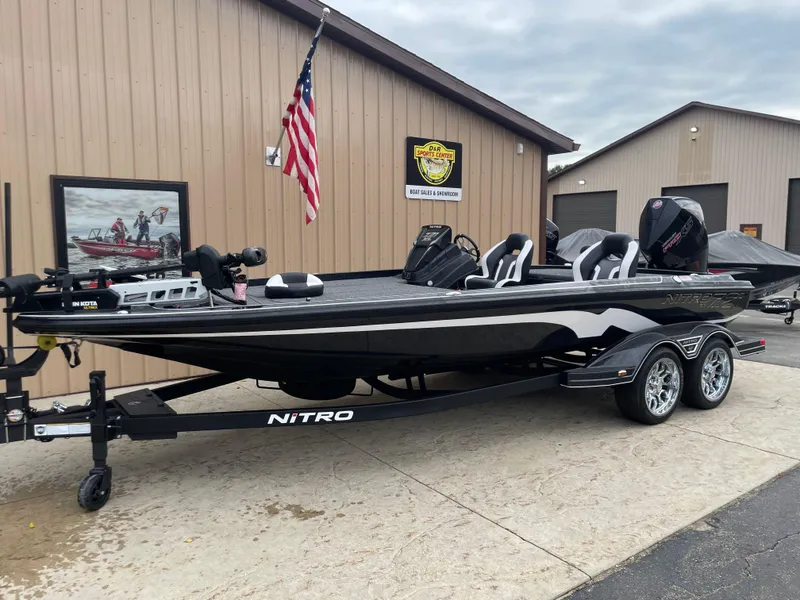 Slide: The Image of 2025 Nitro Z21 XL Pro boat parked outside a building with American flag. - 3