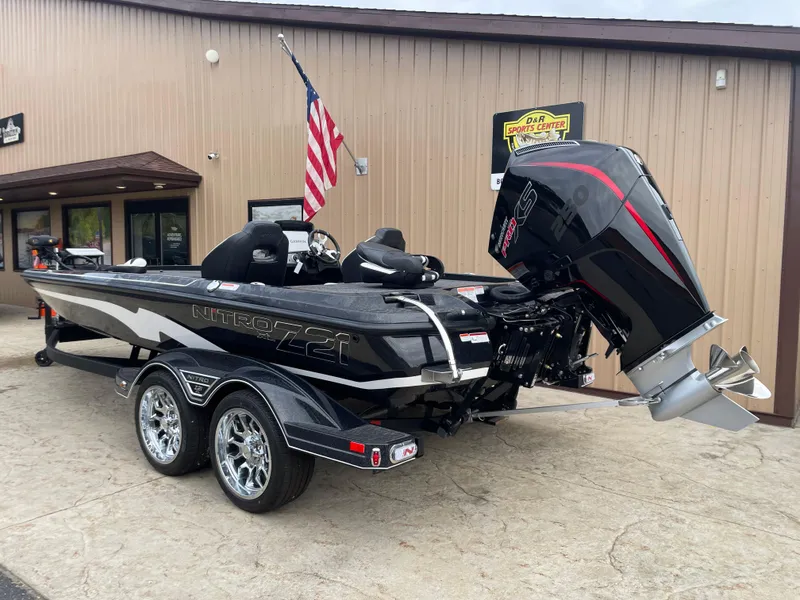 Slide: The Image of 2025 Nitro Z21 XL Pro boat with powerful outboard motor, parked outside a building. - 4