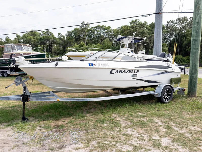 The Image of 2015 Caravelle 19 EBO boat on trailer, parked outdoors. - 1