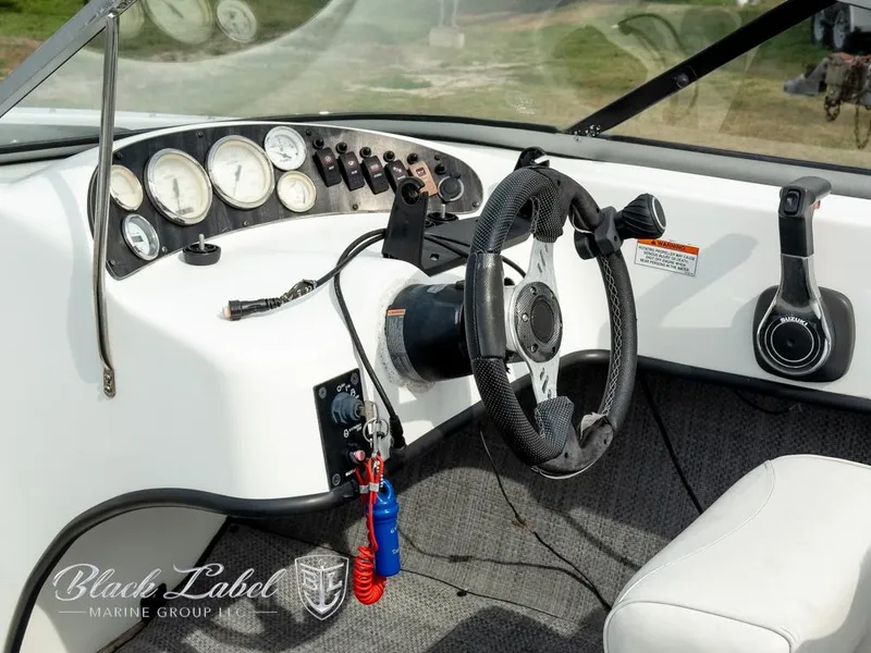 Slide: The Image of Interior of 2015 Caravelle 19 EBO boat with steering wheel and control panel. - 10