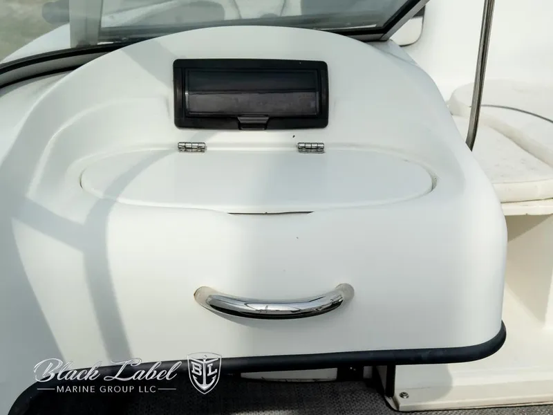 Slide: The Image of 2015 Caravelle 19 EBO boat dashboard with storage compartment and handle. - 11