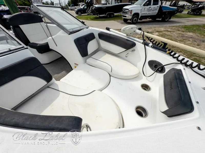 Slide: The Image of 2015 Caravelle 19 EBO boat interior with white seating and black accents. - 5