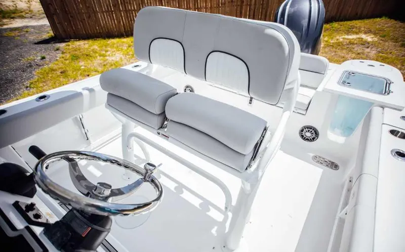 Slide: The Image of 2021 Sea Fox 248 Commander boat interior with steering wheel and cushioned seating. - 10