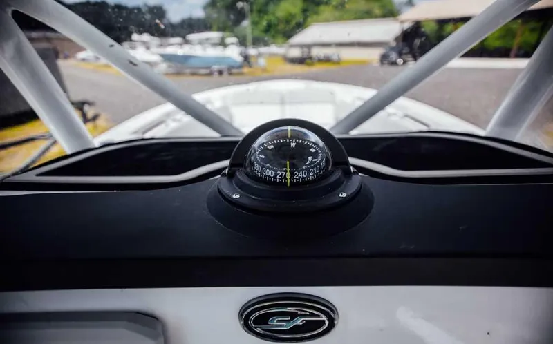 Slide: The Image of Compass on 2021 Sea Fox 248 Commander boat dashboard, with outdoor marina background. - 16