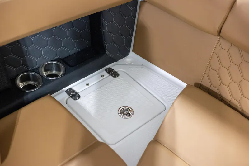Slide: The Image of 2025 Four Winns H4 boat interior with tan seating and integrated cup holders. - 10