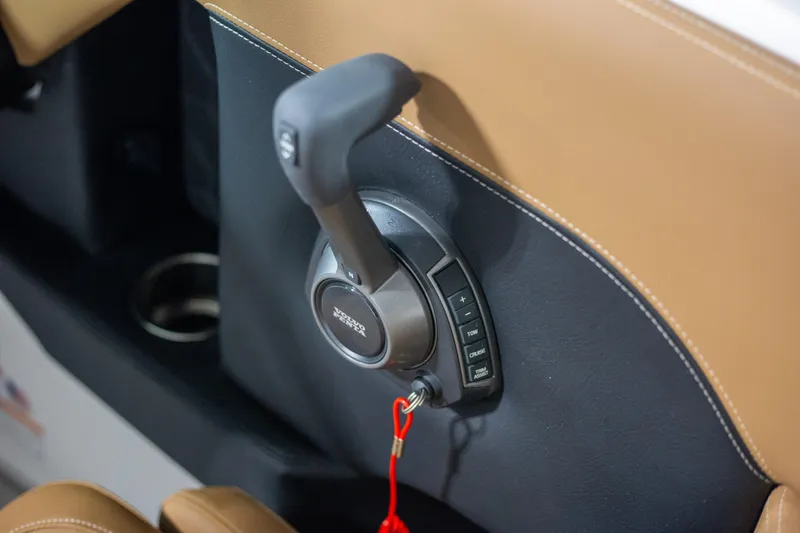 Slide: The Image of 2025 Four Winns H4 boat throttle control with brown leather accents. - 13