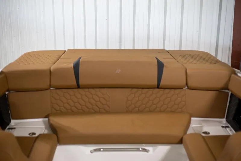 Slide: The Image of 2025 Four Winns H4 boat interior with tan cushioned seating. - 7