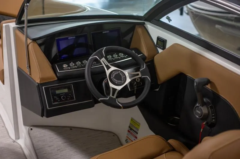 Slide: The Image of Interior of 2025 Four Winns H4 boat, featuring modern dashboard and steering wheel. - 8