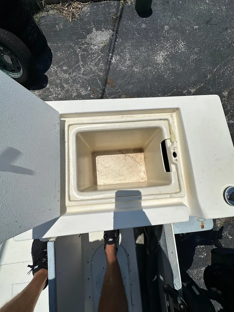 Slide: The Image of Open storage compartment on 1987 Mako 228 boat deck. - 16