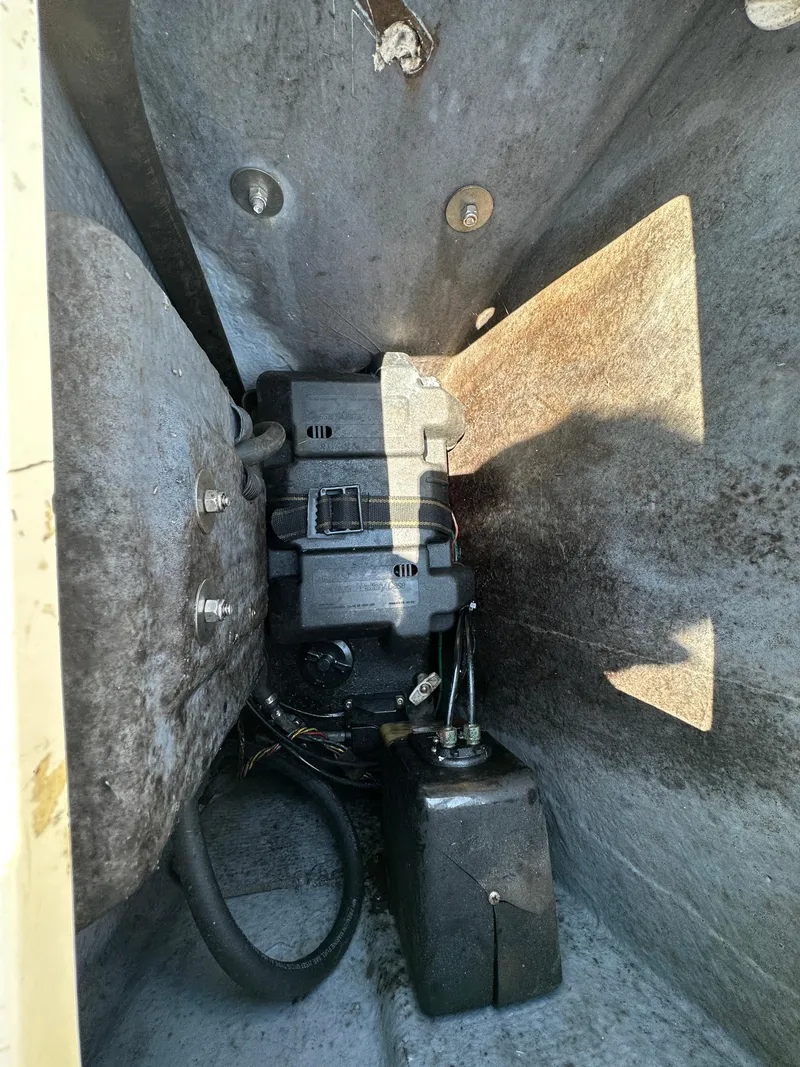 Slide: The Image of 1987 Mako 228 boat engine compartment with visible components and wiring. - 19