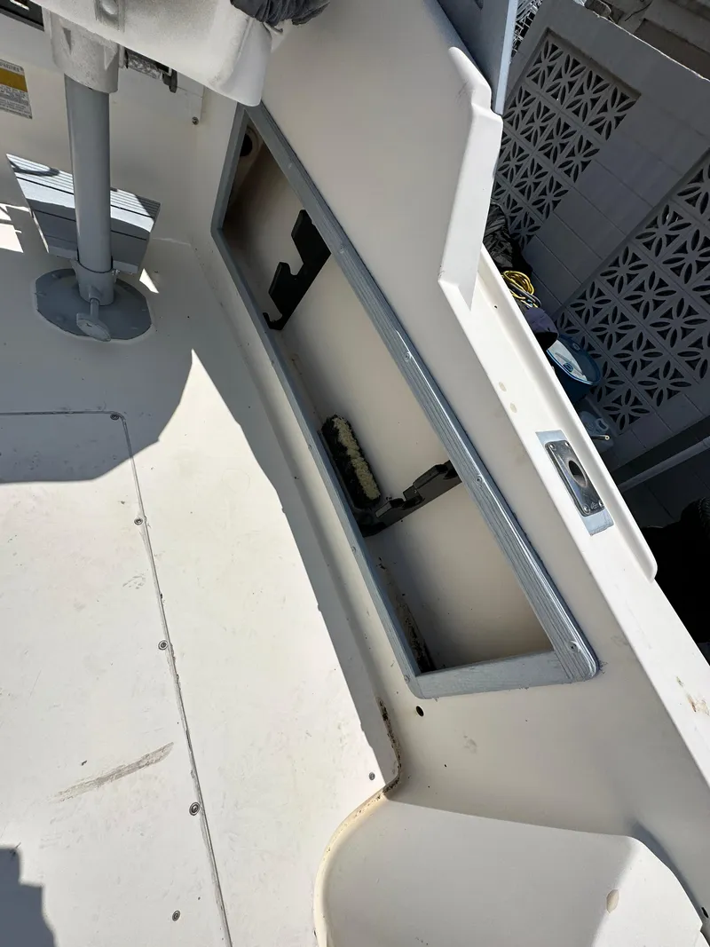 Slide: The Image of 1987 Mako 228 boat interior with open storage compartment. - 22