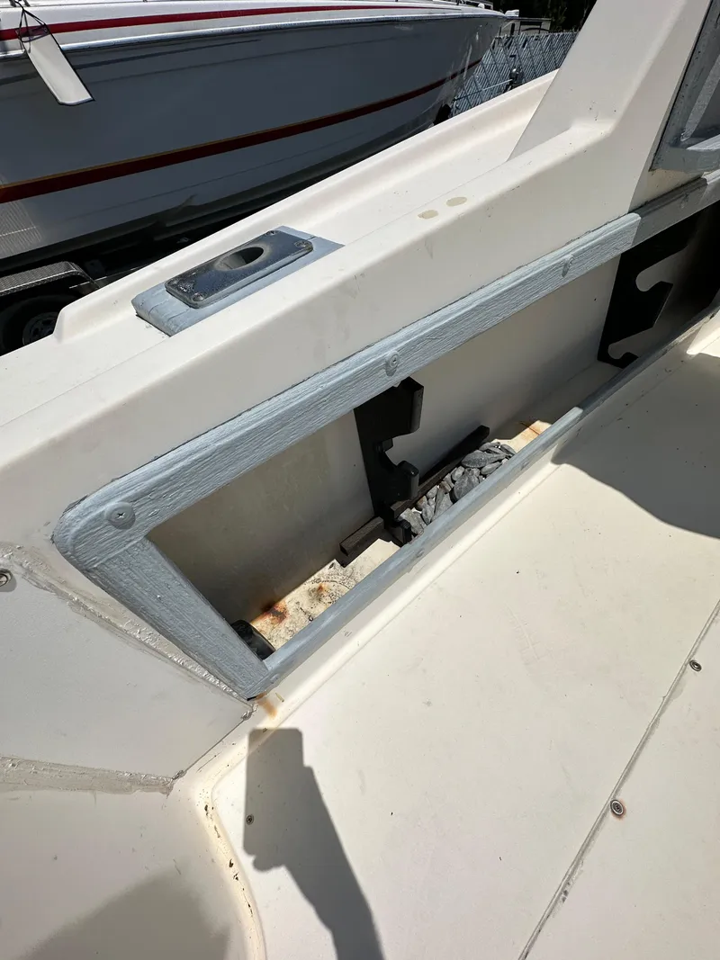 Slide: The Image of 1987 Mako 228 boat interior detail with storage compartment. - 23
