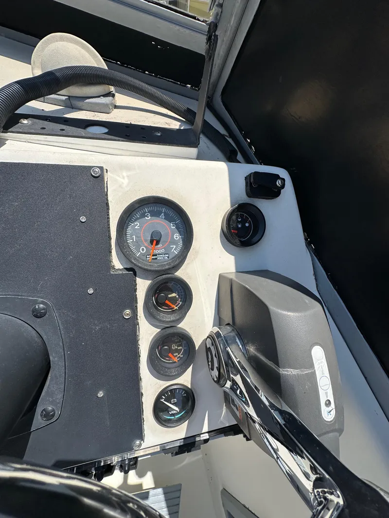 Slide: The Image of Dashboard of a 1987 Mako 228 boat with gauges and controls. - 30