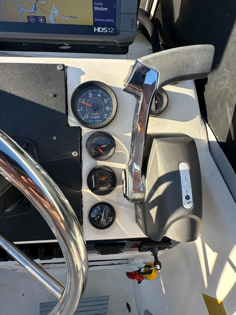 Slide: The Image of Close-up of 1987 Mako 228 boat dashboard with gauges and controls. - 5