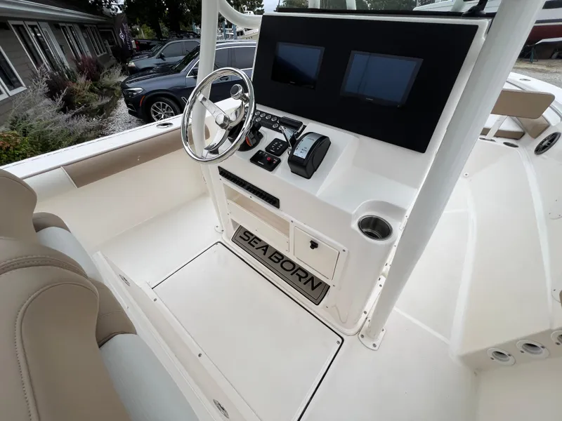 Slide: The Image of 2023 Sea Born LX24 Center Console boat interior with steering wheel and control panel. - 10