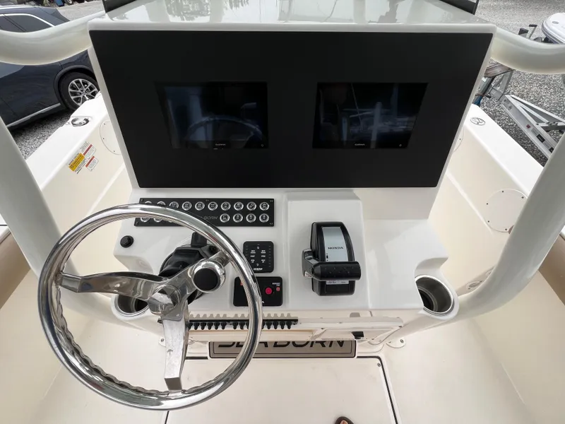 Slide: The Image of 2023 Sea Born LX24 Center Console dashboard with dual screens and steering wheel. - 11