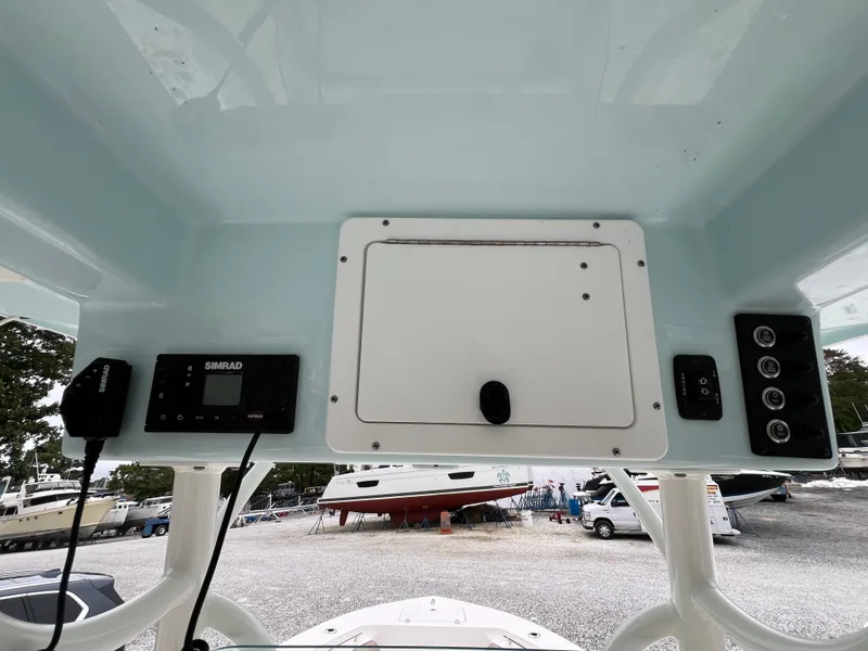 Slide: The Image of 2023 Sea Born LX24 Center Console dashboard with electronic controls and storage compartment. - 12