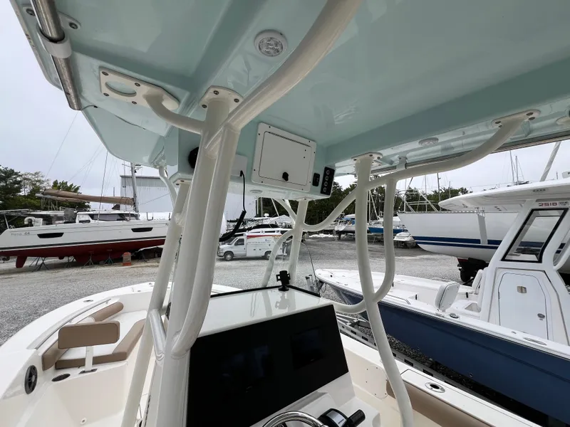 Slide: The Image of 2023 Sea Born LX24 Center Console boat interior with modern dashboard and overhead structure. - 13