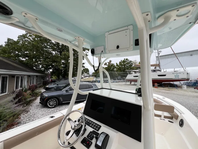 Slide: The Image of 2023 Sea Born LX24 Center Console boat interior with steering wheel and dashboard. - 14