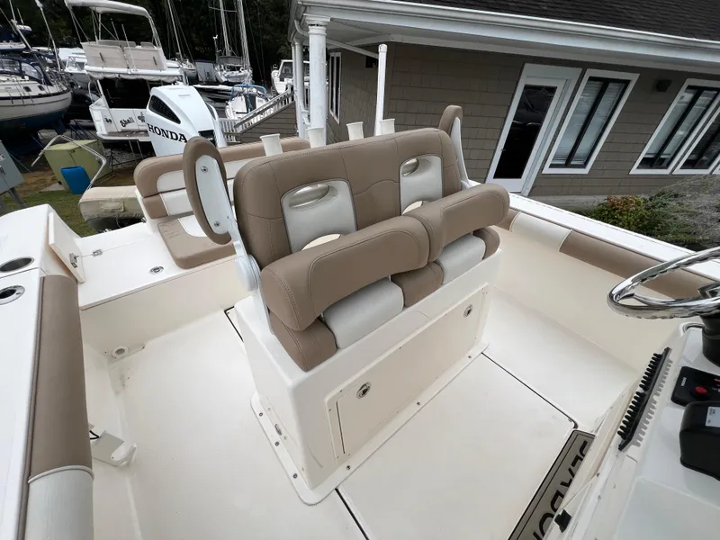 Slide: The Image of 2023 Sea Born LX24 Center Console boat with beige seating and storage compartments. - 15
