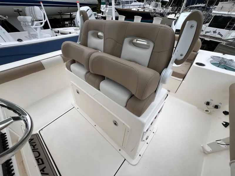 Slide: The Image of 2023 Sea Born LX24 Center Console boat seating area with tan cushions. - 16