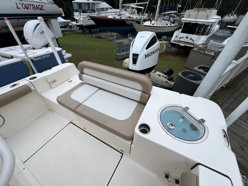 Slide: The Image of 2023 Sea Born LX24 Center Console boat with Honda outboard motor at marina. - 17