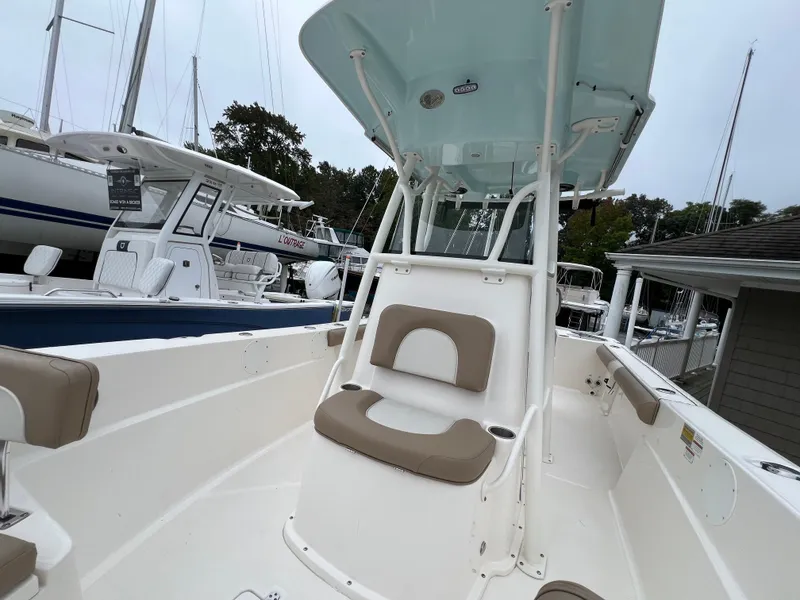 Slide: The Image of 2023 Sea Born LX24 Center Console boat with seating, docked at marina. - 5