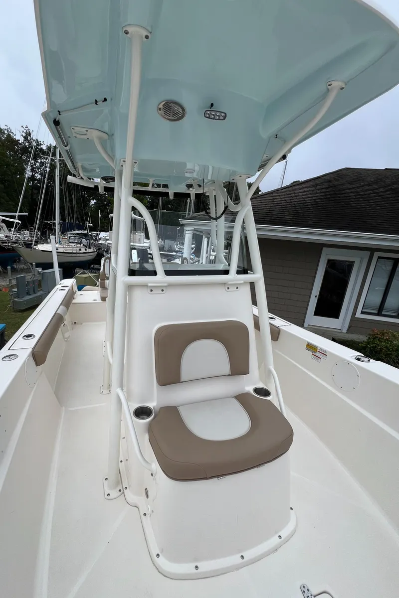 Slide: The Image of 2023 Sea Born LX24 Center Console boat with cushioned seating and canopy. - 7