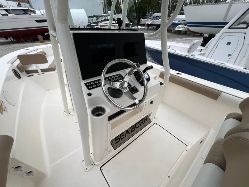 Slide: The Image of 2023 Sea Born LX24 Center Console boat interior with steering wheel and controls. - 9