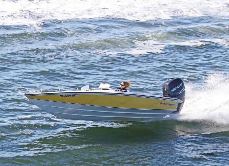 Slide: The Image of 1990 Superboat 21 speeding on ocean waves, featuring a yellow and white design. - 10