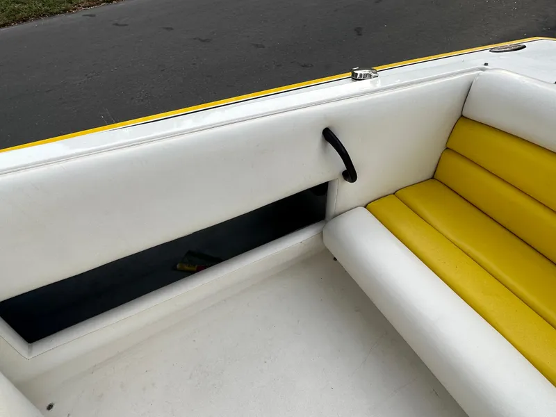 Slide: The Image of Interior of 1990 Superboat 21 with white and yellow seating. - 13