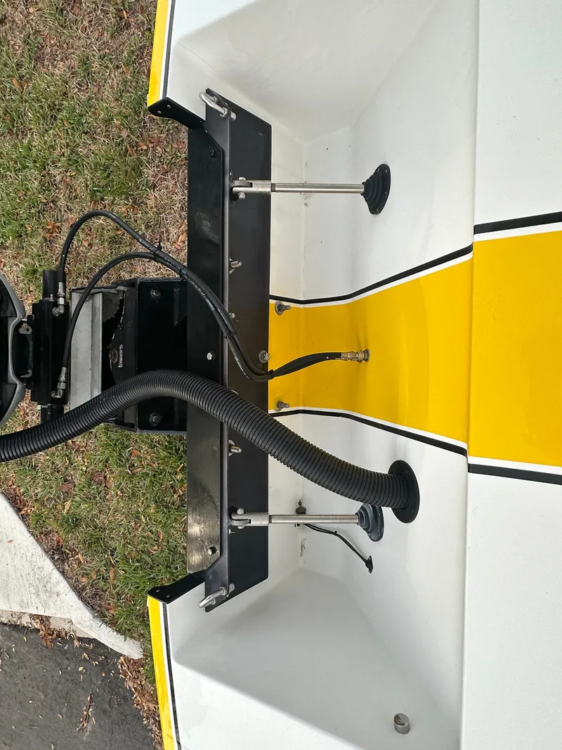 Slide: The Image of 1990 Superboat 21 with yellow and white hull, showing engine mount and cables. - 26