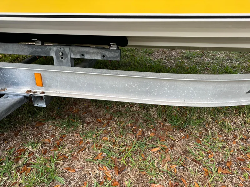 Slide: The Image of Yellow 1990 Superboat 21 on trailer, parked on grass. - 34