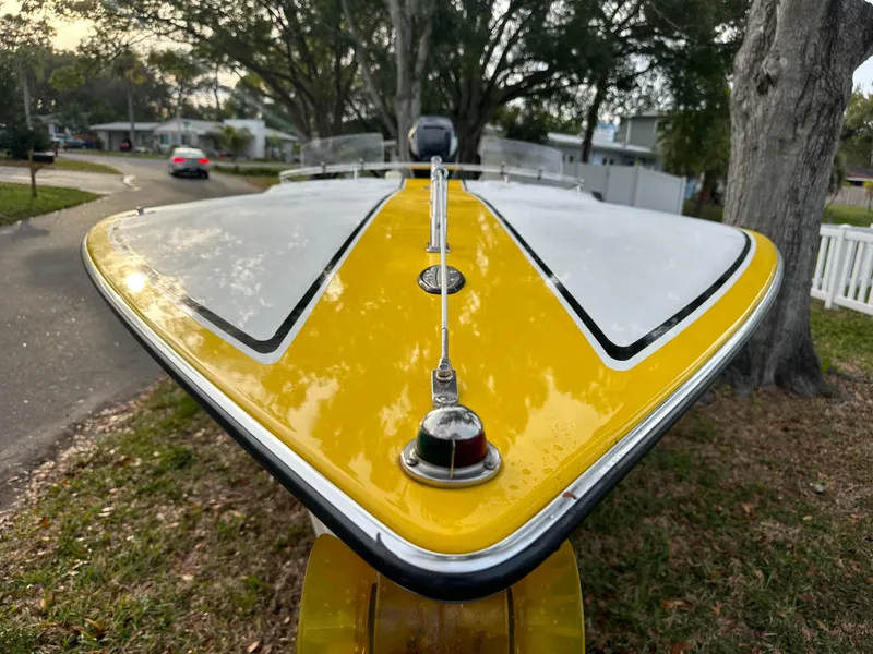 Slide: The Image of 1990 Superboat 21 with yellow and white design, parked outdoors. - 37