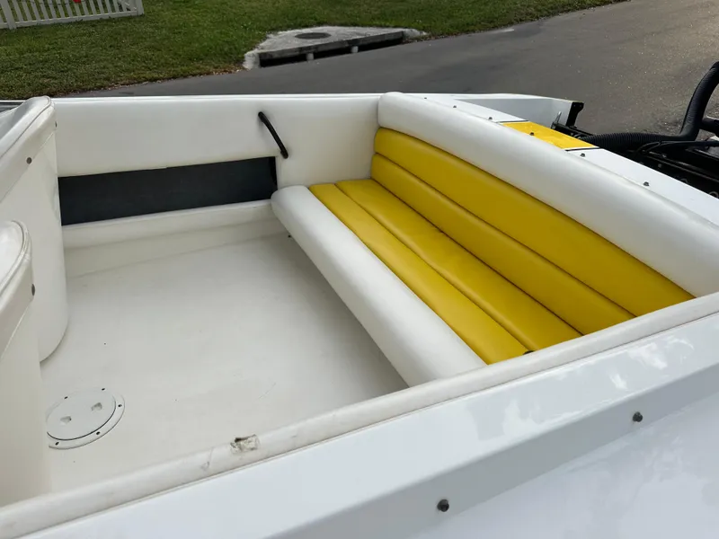 Slide: The Image of 1990 Superboat 21 interior with yellow and white seating. - 39