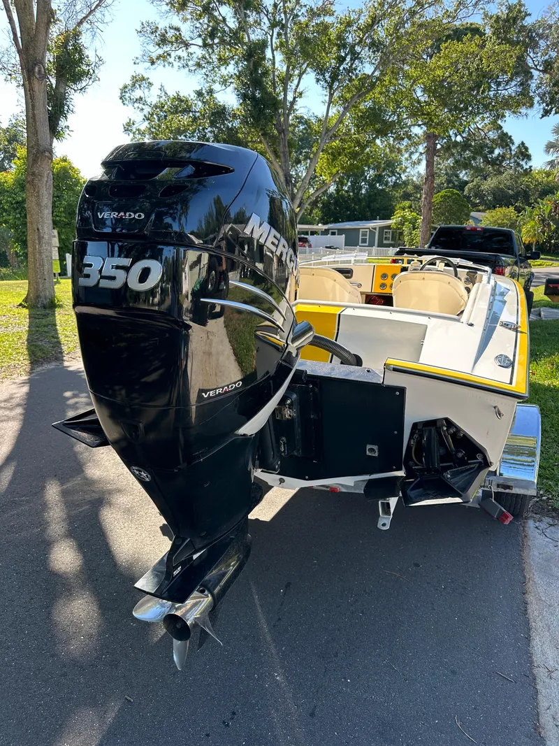 Slide: The Image of 1990 Superboat 21 with Mercury 350 Verado engine, parked outdoors. - 4