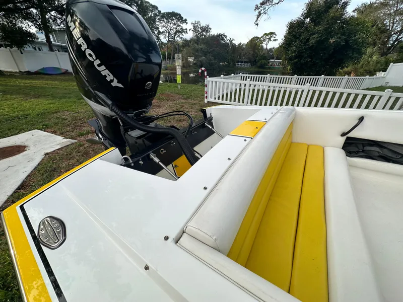 Slide: The Image of 1990 Superboat 21 with Mercury engine, yellow and white interior, parked outdoors. - 41