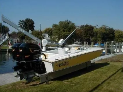 Slide: The Image of 1990 Superboat 21 with dual engines docked by a marina. - 43