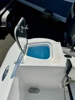 Slide: The Image of 2025 Tidewater 210CC Adventure boat with open storage compartment. - 7