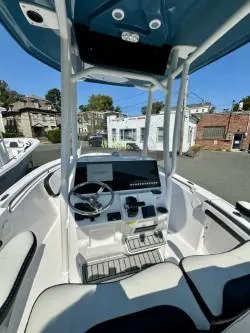 Slide: The Image of 2025 Tidewater 210CC Adventure boat interior with modern console and seating. - 9