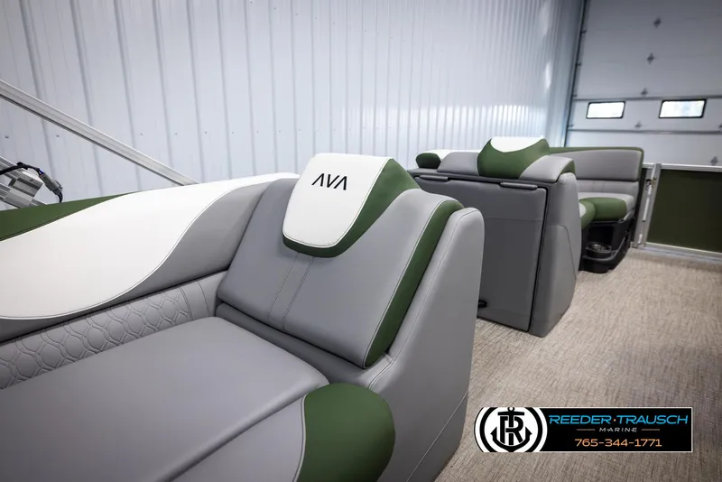 Slide: The Image of 2025 Avalon LSZ CRB boat interior with gray and green seating in a showroom. - 22