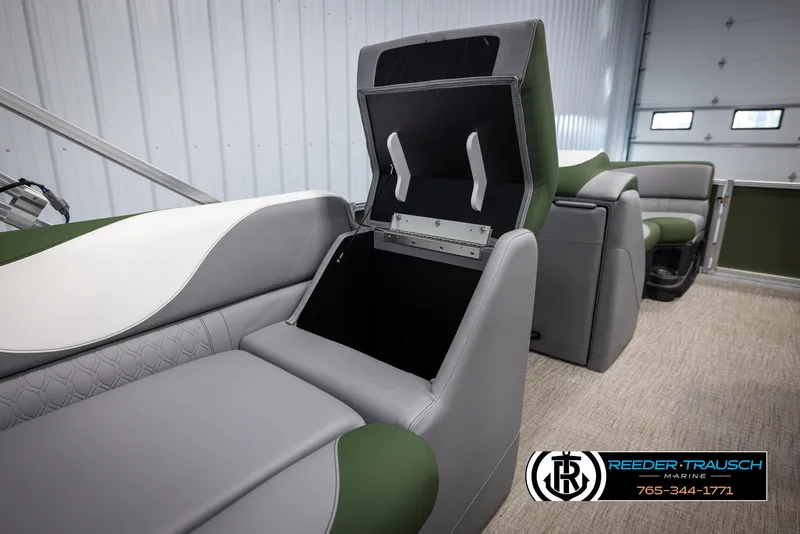 Slide: The Image of 2025 Avalon LSZ CRB boat interior with open storage compartment, gray and green seating. - 23