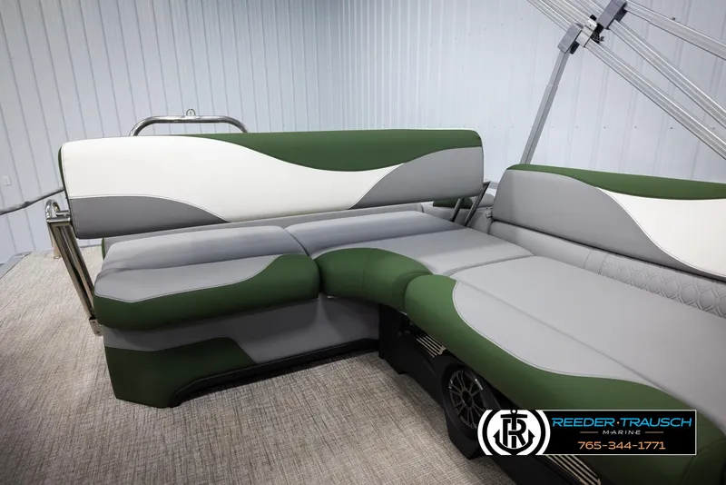 Slide: The Image of 2025 Avalon LSZ CRB boat interior with green and gray seating, Reeder-Trausch Marine logo. - 25