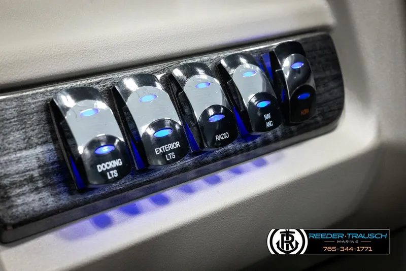 Slide: The Image of Control panel of 2025 Avalon LSZ CRB with illuminated switches for docking, exterior lights, and radio. - 35