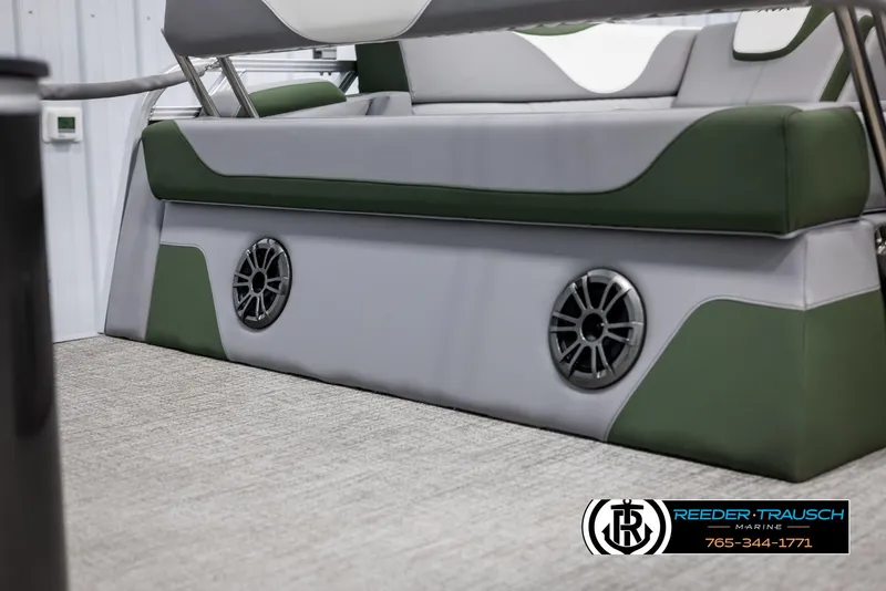 Slide: The Image of 2025 Avalon LSZ CRB boat interior with green and gray seating and built-in speakers. - 44
