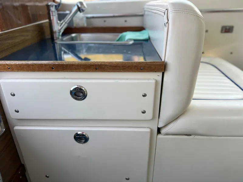 Slide: The Image of 1968 Chris-Craft COMMANDER 27 interior with sink and white seating. - 11