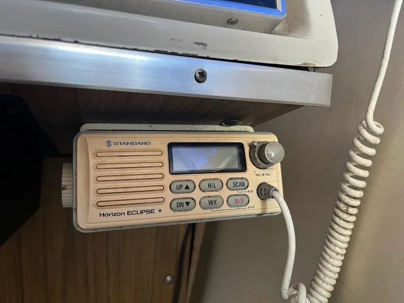 Slide: The Image of Vintage marine radio on 1968 Chris-Craft COMMANDER 27 boat, featuring Standard Horizon Eclipse model. - 13