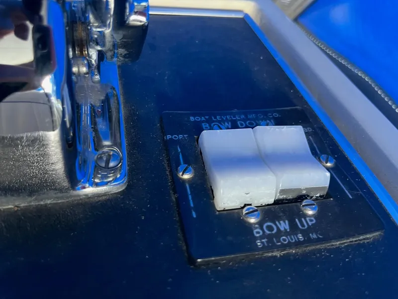 Slide: The Image of Control panel of a 1968 Chris-Craft COMMANDER 27 boat, featuring bow adjustment switches. - 16