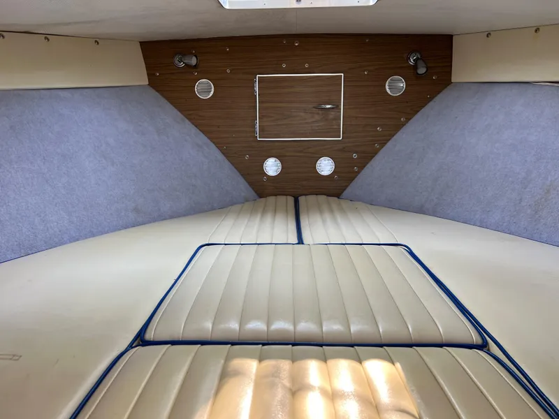 Slide: The Image of 1968 Chris-Craft COMMANDER 27 cabin interior with beige seating and wood paneling. - 18